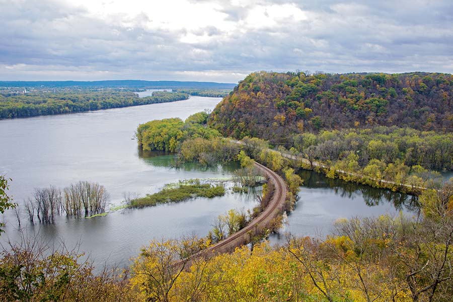 Contact - Aerial View of a River Surrounded by Mountains with Colorful Fall Foliage in Iowa